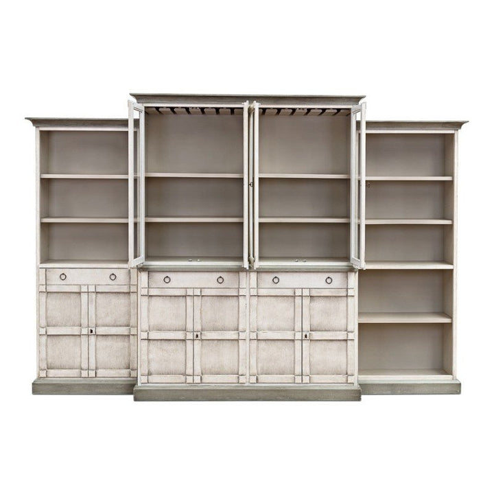 The Sarreid 4 Piece Full Wall Unit Bookcase in White & Grey combines transitional style with practical storage, featuring multiple shelves and closed compartments. This unit consists of three sections: the middle section has two open cabinet doors revealing additional shelving inside, while the sides feature solid doors and drawers, all crafted from solid pine.