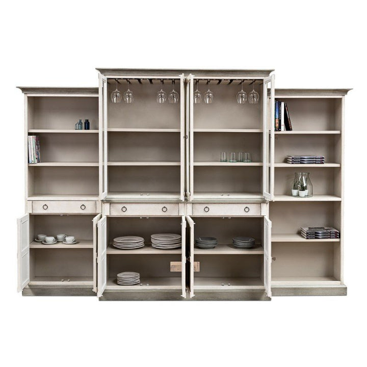 The Sarreid 4 Piece Full Wall Unit Bookcase in white and grey showcases a large, transitional-style design crafted from solid pine. It features multiple shelves and compartments, including two central shelves designed to hold wine glasses hanging upside down. The lower compartments are perfect for storing plates, bowls, and other dishware, while the side shelves can elegantly display books, decorative items, glasses, and bottles.