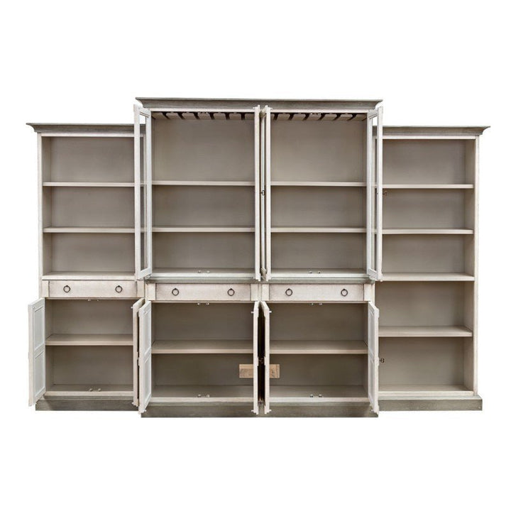 The Sarreid 4 Piece Full Wall Unit Bookcase in White & Grey is a spacious, multi-compartmental wooden cabinet featuring six shelving sections. This transitional-style unit includes central open shelves with doors ajar, showcasing bare interior spaces. Below the shelves, there are both closed and open drawers and cupboards for versatile storage options.