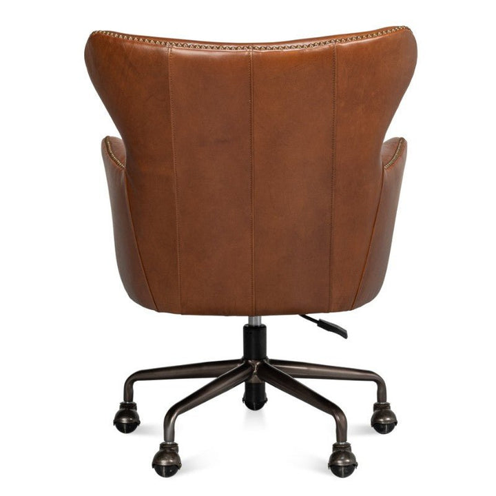 The Andrew Jackson Desk Chair in Havana Leather by Sarreid boasts a curved backrest and intricate stitching details. Displayed from the rear, this transitional design is set on a metal base with five caster wheels for easy mobility.