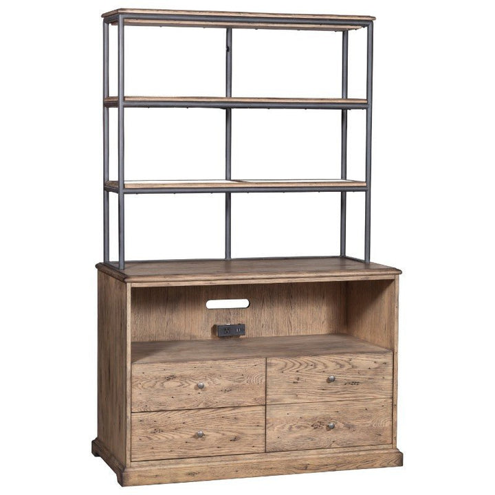 The Arcadian Lateral File Cabinet by Fairfield Chair exudes rustic charm with its wooden craftsmanship and rustic finish. The bottom section includes two cabinet doors on the left and two drawers on the right, while the top section features two open metal-framed shelves for modern storage solutions. Additionally, there is a cord management hole and a power outlet in the middle for added functionality.