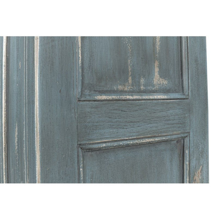 Close-up image of the Banner Bungalow Bookcase by Sarreid, showcasing its distressed, weathered turquoise finish. Part of the Bungalow Collection, this bookcase features two vertical panels with visible wear, giving it a rustic, vintage appearance with faded and chipped paint that reveals the Russian pine wood underneath.