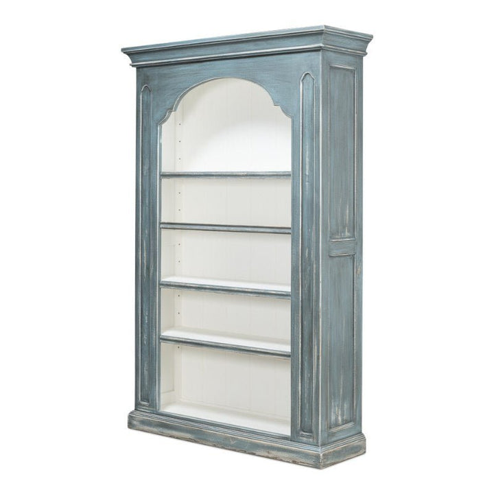 The Sarreid Banner Bungalow Bookcase is a vintage-style wooden bookshelf crafted from Russian pine, showcasing a distressed blue exterior and a white interior. This tall piece features five open shelves framed by fluted columns and an arched top section, complemented by a beveled base and intricate molding on the top edge.