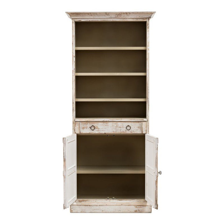 Presenting the Sarreid "Bookcase With Doors, Disrupted White," this piece showcases a rustic charm with its distressed wood finish. It features two closed storage doors at the base, a convenient open drawer in the center, and four open shelves above ideal for both storage and display, making it a charming addition to any room.