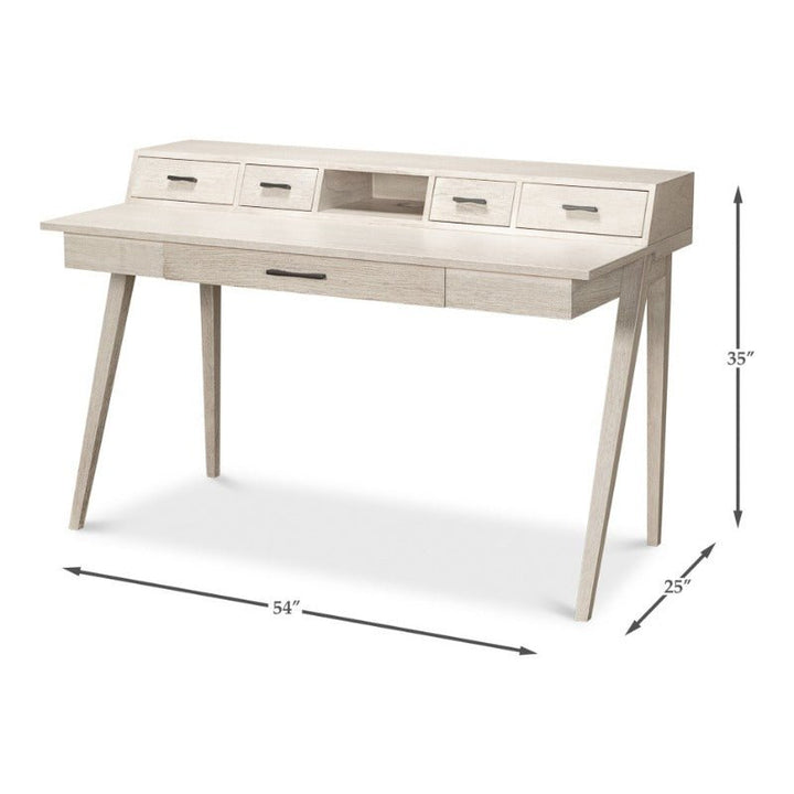 The Covet Desk by Sarreid is a modern desk with practical functionality. It features a light wood finish with an Ivory Bianca sheen, including four small upper drawers, a central open cubby, and a large lower drawer. The desk boasts a clean, minimalist design with angled legs and measures 54" wide, 25" deep, and 35" high.