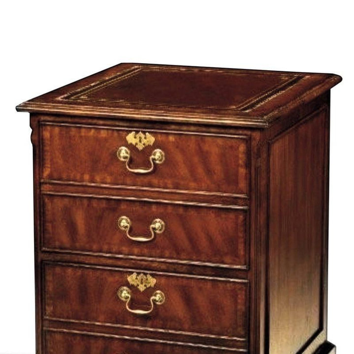 Introducing the Crotch Mahogany File Cabinet by Aston Court, an exquisite piece of luxurious craftsmanship. This wooden chest of drawers boasts a polished, deep brown finish with three spacious drawers, each adorned with brass handles and intricate keyhole covers. The top surface is elegantly wider with fine detailing along its edges, all beautifully set against a plain white background.