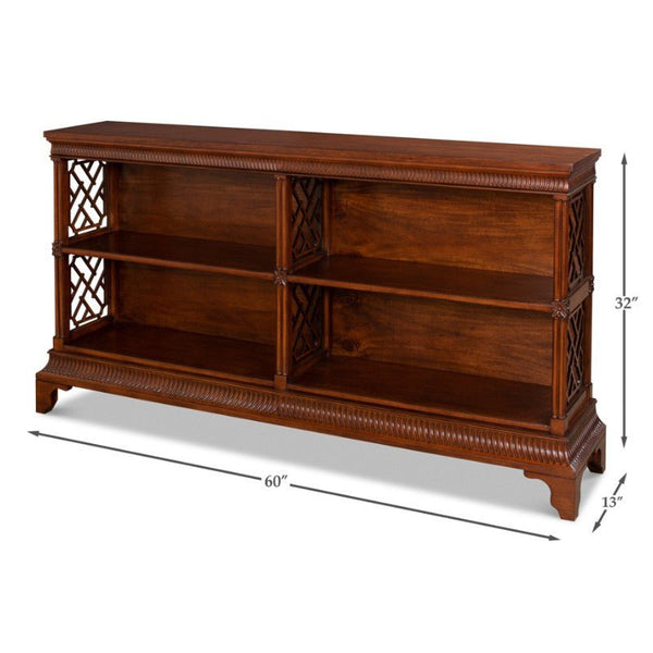 The Double Chepstow Book Case by Sarreid is a wooden bookshelf with a rich, dark solid walnut finish and intricately carved designs on its sides that resemble Thomas Chippendale’s style. This unit features two tiers of shelving divided into four sections and measures 60 inches wide, 32 inches high, and 13 inches deep.