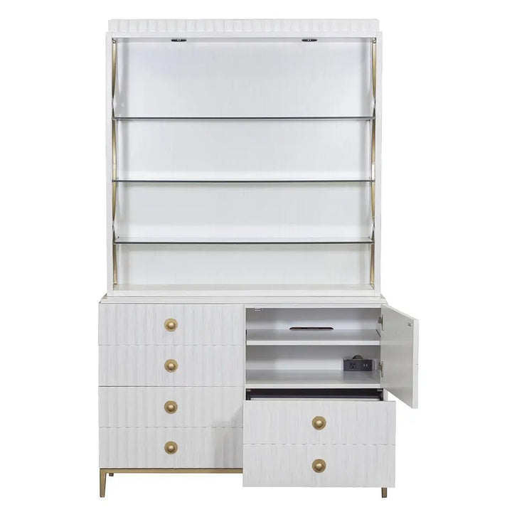 The East Camden Lateral File Cabinet by Fairfield Chair is a white, modern piece exuding casual elegance. It features four drawers and an open shelf space above, with Antique Brass hardware knobs on the drawers and cabinet door. One drawer and the cabinet door are partially open, revealing an empty interior and a small safe.