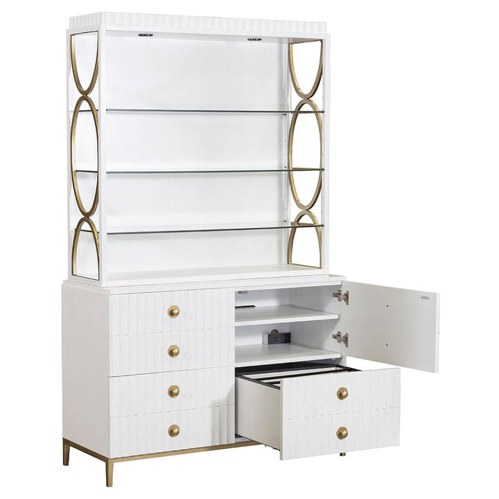 The East Camden Lateral File Cabinet by Fairfield Chair exudes casual elegance with its white finish and gold accents. It features three glass shelves on top, along with four drawers and two cabinet doors at the bottom. For added convenience, one drawer and one door reveal additional interior storage space. The sides are adorned with decorative circular gold elements, while antique brass hardware adds a refined touch.