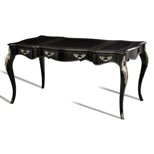 The Ebonized Writing Desk by Aston Court is a black rectangular table with a classic design, featuring ornate curved legs and intricate gold detailing on the legs and front. The desk has three shallow drawers adorned with luxurious materials, including antique nickel-plated brass accents, and a smooth tabletop surface.