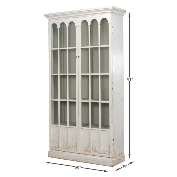 The Edgar Allan Glass Bookcase by Sarreid is a tall, vintage-style white cabinet that measures 91 inches in height, 50 inches in width, and 18 inches in depth. This reclaimed pine bookcase features two large doors with multiple glass panels, showcasing a slightly distressed finish that embodies a traditional design with its charming whitewash look.