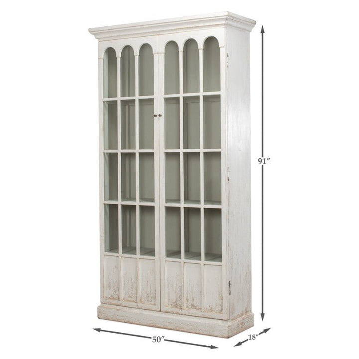 The Edgar Allan Glass Bookcase by Sarreid is a tall, vintage-style white cabinet that measures 91 inches in height, 50 inches in width, and 18 inches in depth. This reclaimed pine bookcase features two large doors with multiple glass panels, showcasing a slightly distressed finish that embodies a traditional design with its charming whitewash look.