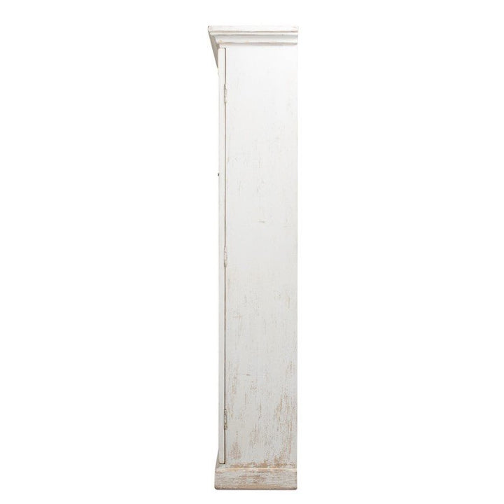 Side view of the Edgar Allan Glass Bookcase by Sarreid, a tall, distressed white wooden cabinet with a traditional design. The image showcases its thin and sleek profile, slightly beveled front edge, and top. The surface features a rustic, worn look with visible wood texture and aged paint effects similar to a reclaimed pine bookcase in whitewash finish.