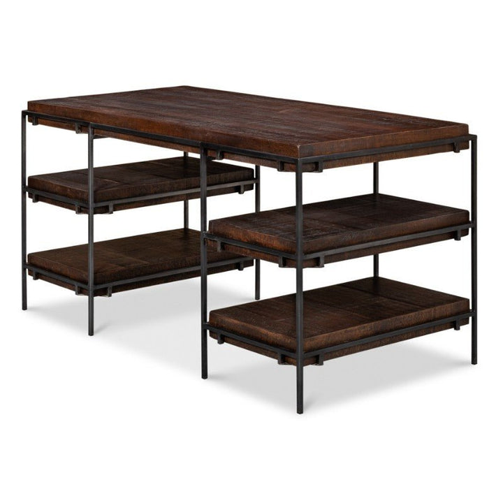 The Sarreid Ernest Desk is crafted from mango wood and iron, measuring 60 inches. This home office desk features a dark brown finish with a metal frame and boasts a rectangular top surface along with two lower wooden shelves on each side, offering extra storage or workspace. The design elegantly combines industrial and rustic elements.