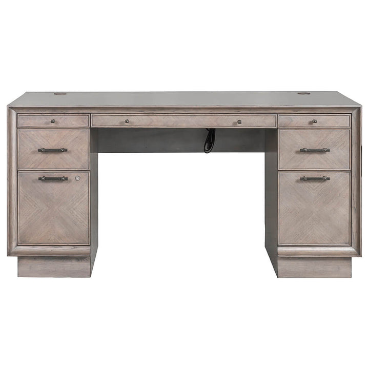 The Expedition Pedestal Desk 60" by Fairfield Chair is a spacious, light wooden desk with an Art Deco design. It features two sets of drawers on each side, each consisting of two deep drawers and one smaller drawer at the top. The central drawer and cable management grommets enhance its practicality, while the eucalyptus veneer adds a touch of elegance.