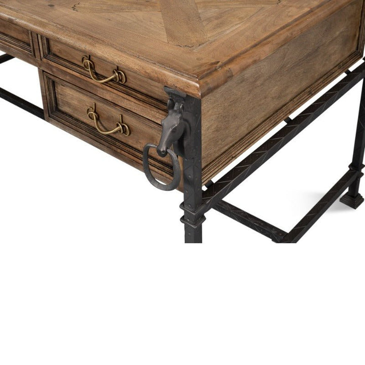 The Game Of Thornes Desk - Sarreid by Sarreid showcases a distinctive design with its herringbone-patterned tabletop crafted from reclaimed old wood. It features two drawers with brass handles, robust metal legs, and a unique metal horse head detail on the corner.