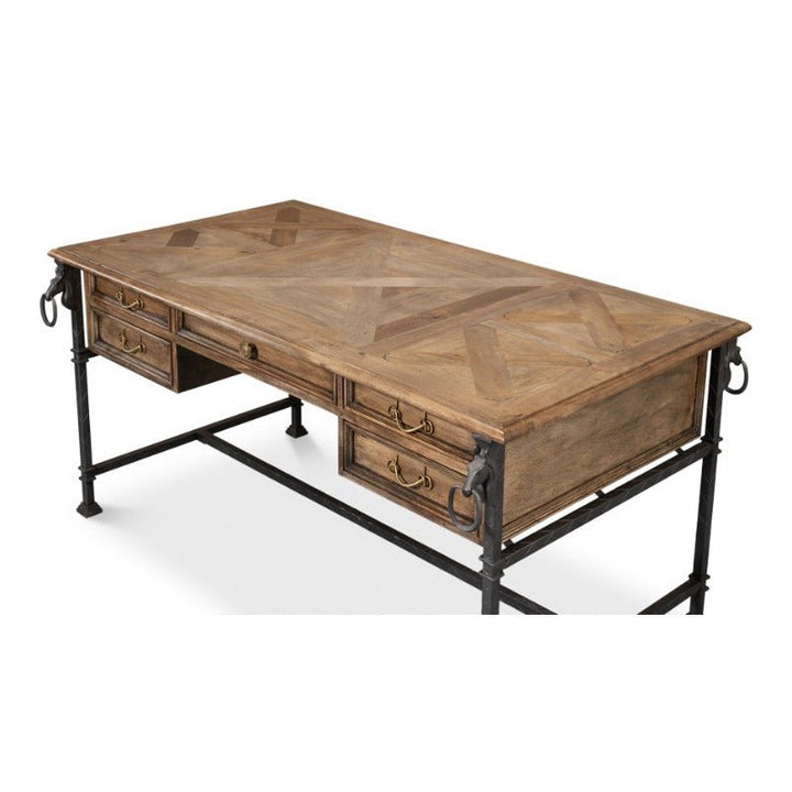 Introducing the Game Of Thornes Desk by Sarreid, a masterfully designed wooden desk with a rustic finish and sturdy metal legs. It features four drawers, each equipped with handle pulls on either side. The desktop boasts an elegant geometric pattern crafted from reclaimed old wood, enhanced by metal rings adorning the front corners for a unique touch.