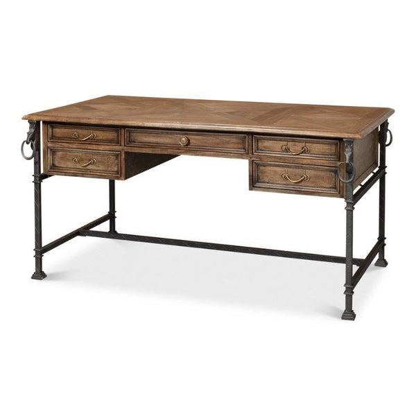 The Game of Thornes Desk by Sarreid is a wooden desk crafted from reclaimed old wood, featuring a rustic finish and a rectangular top. It includes four drawers with metal handles on each side and one central drawer. This distinctive desk is supported by black metal legs with a twisted design and ring accents.