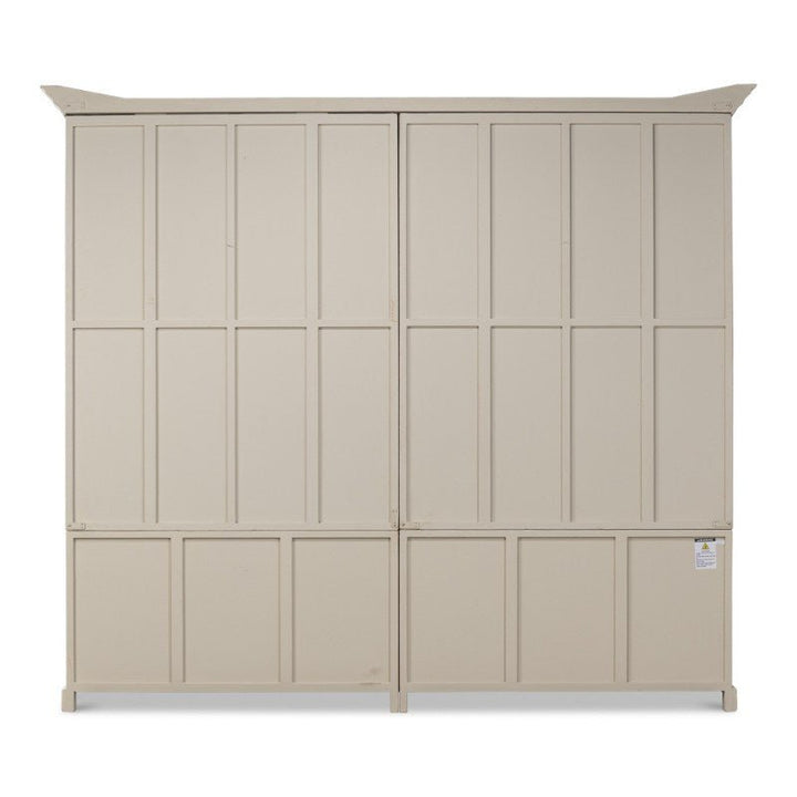 The Glass Front Bookcase by Sarreid is a spacious, beige-colored metal storage solution with double doors. Featuring paneled doors that add a rustic farmhouse charm, it also has a small label attached to the lower right section. Set against a plain white background, this elegant bookcase offers ample storage space.