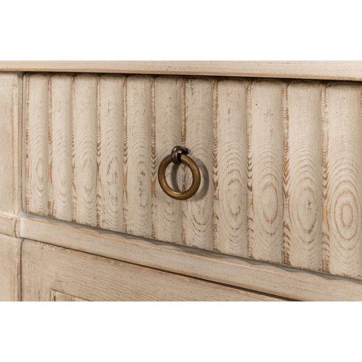 Close-up of a distressed, stone grey wood drawer from the Sarreid Inspire Desk, showcasing vertical grooves and a round, brass ring pull handle. The visible grain patterns in the wood lend a rustic, vintage look that enhances its compact design.