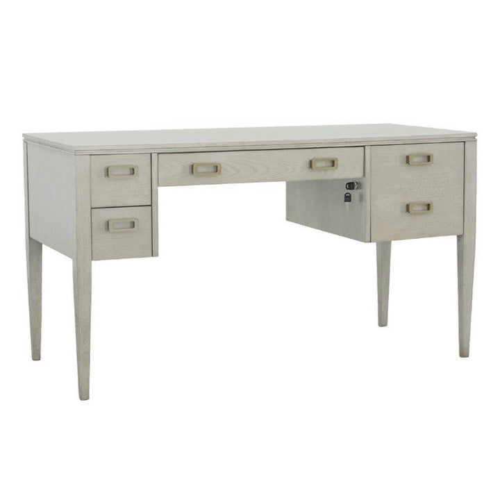 The Libby Langdon Patton Desk 54" by Fairfield Chair showcases a sophisticated dove gray finish and includes five drawers, with one lockable on the right side. Its classic design features tapered legs and square drawer handles, elegantly accented with brass hardware for a timeless appeal.