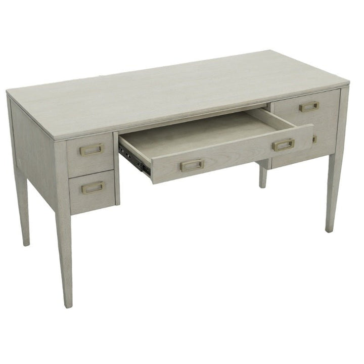 The Libby Langdon Patton Desk 54" by Fairfield Chair, in a sheer dove gray finish, features four drawers with clean lines and simple rectangular brass hardware handles. An additional central drawer is partially open, revealing its practical design and elegance.