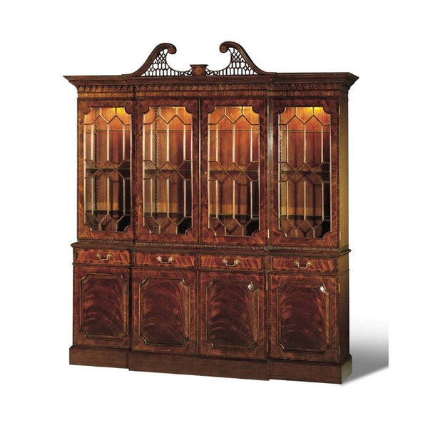 The Mahogany Breakfront Bookcase by Aston Court is a large, elegant hutch featuring intricate carvings on top. Its upper section has glass doors with a geometric design that showcases the interior shelves, while the lower section consists of closed wooden cabinets. The wood boasts a polished, dark finish of exquisite crotch mahogany.