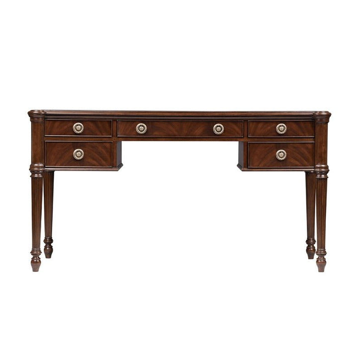 The Mahogany Lady's Desk from Aston Court features a dark brown finish, six drawers arranged in pairs of three on each side, fluted legs, a flat rectangular surface, and ornate round drawer pulls. This desk's design echoes classic or antique furniture styles.