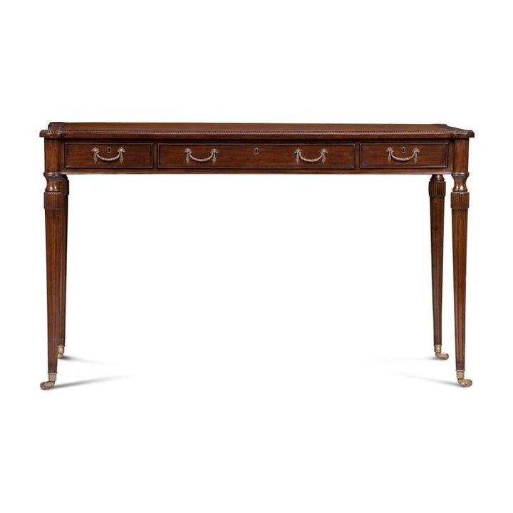 The Aston Court Mahogany Leather Top Writing Desk exudes timeless elegance with its vintage design. Featuring three front drawers with brass handles and tapered legs adorned with brass feet, the desk showcases a polished finish, clean lines, and a refined simplicity. This exquisite piece adds an air of sophistication to any space.