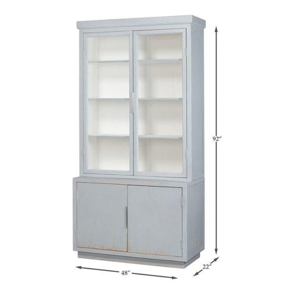 The Maldives 2 Door Bookcase by Sarreid, finished in Eros Blue, is a tall cabinet crafted from reclaimed oak. It features two glass-paneled upper doors that reveal multiple shelves inside, while the lower section has solid double doors for additional storage. The dimensions are 92 inches tall, 48 inches wide, and 22 inches deep.