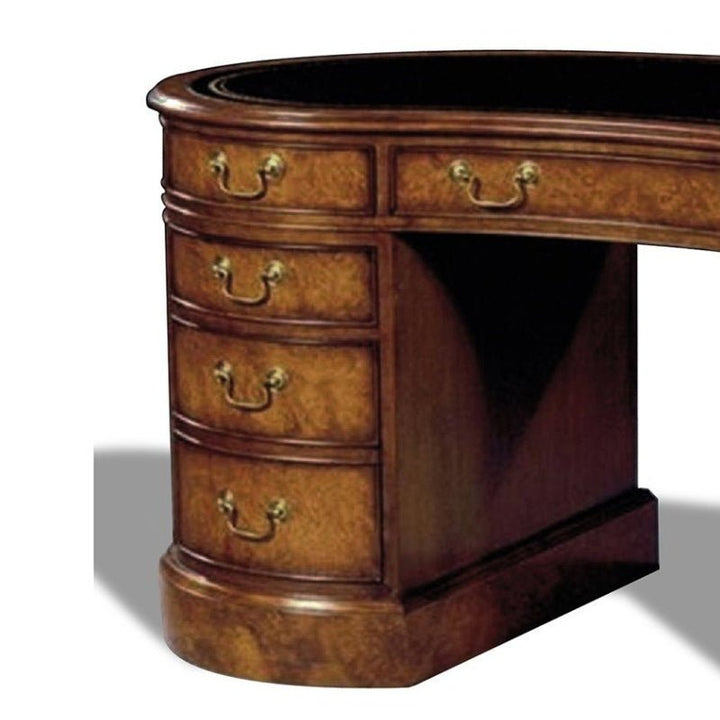 A close-up shot of the corner of the Myrtle Burl Kidney Writing Desk by Aston Court showcases its rounded edge and column of multiple drawers adorned with brass handles. The polished finish on the rich brown wood highlights the classic design and craftsmanship, echoing the elegance reminiscent of antique leather top desks.