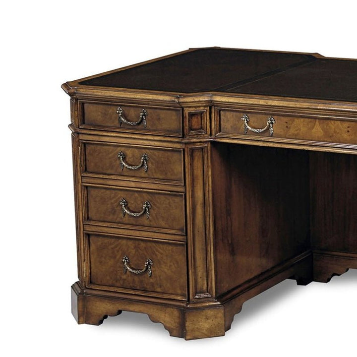 The Myrtle Writing Desk by Aston Court features a distinguished black leather top that enhances its sophisticated appeal. This vintage wooden piece includes four drawers on the left side, each adorned with ornate metal handles. The wood flaunts a luxurious brown finish, while the desktop surface's leather inlay exudes an air of elegance. The base is complemented by decorative molding and a traditional design, making it an exquisite addition to any space.