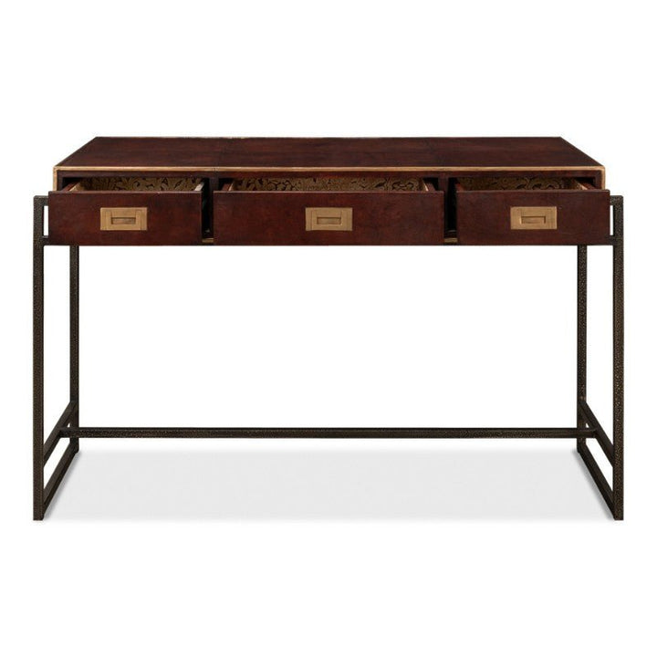 The Old Leather Desk by Sarreid offers a modern aesthetic with its sleek iron frame and three wooden drawers. Featuring a hand-colored leather top, this 49-inch desk embraces minimalist design with a rectangular surface and open space underneath. The drawers include label holders and subtly ornate inner faces, showcasing a transitional style.