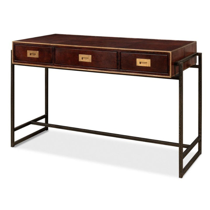 The Sarreid Old Leather Desk is a sleek, three-drawer wooden desk with gold-colored handles, featuring an elegant and minimalist dark iron frame. This 49-inch desk combines a modern, industrial aesthetic with transitional style elements, providing practical storage space.