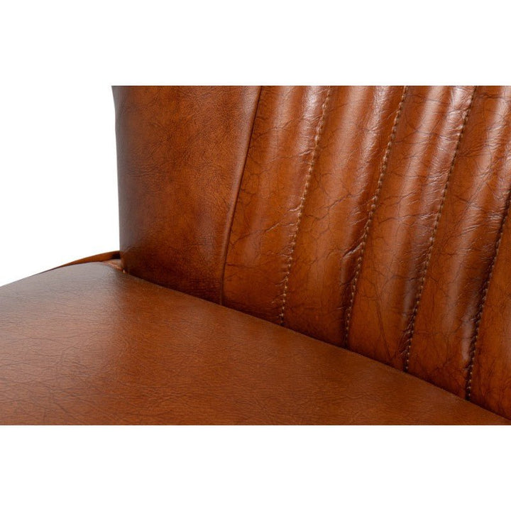 Close-up of the Sarreid Parker Office Chair seat and backrest in Vintage Havana Leather, featuring stitched vertical seams. The top-grain cow leather exhibits a textured, slightly aged appearance with visible fine creases. The image highlights the craftsmanship and material detail of this exquisite furniture piece.