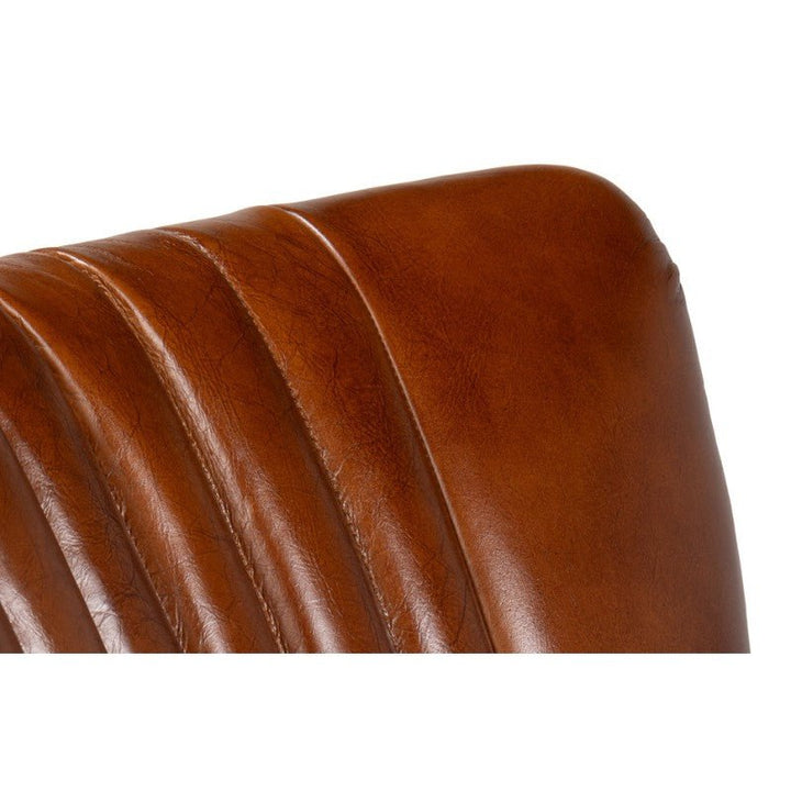 Close-up of the corner of a Parker Office Chair in Vintage Havana Leather by Sarreid, highlighting the vertical stitching on the backrest. The top-grain cow leather looks smooth with slight creasing, offering a well-worn, vintage appearance. The background remains plain and white.