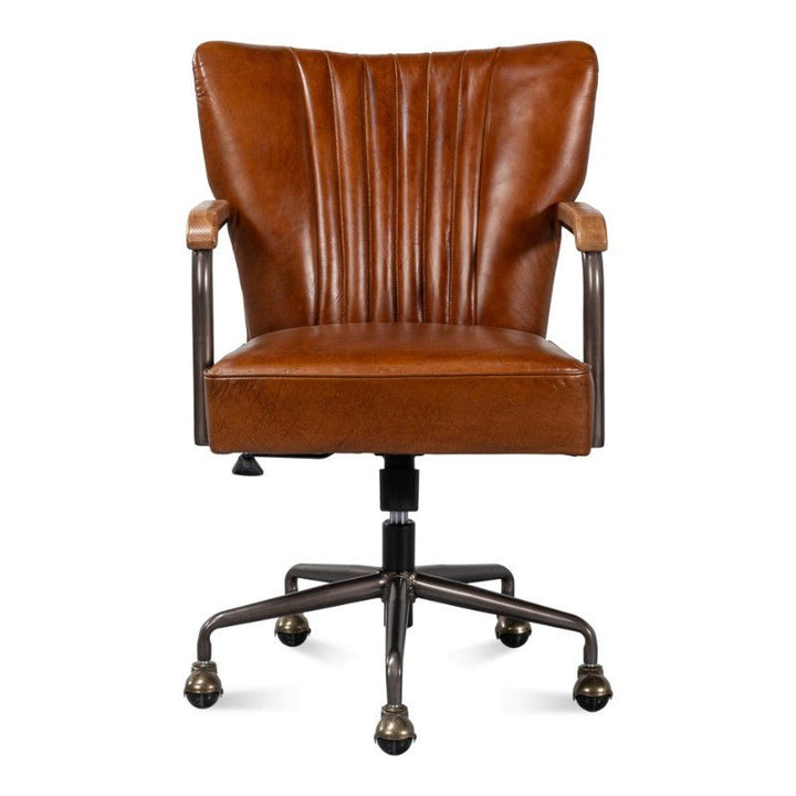 The Parker Office Chair in Vintage Havana Leather by Sarreid features a ribbed backrest design and padded armrests. It sits on a black metal swivel base with five caster wheels. This office chair artfully combines both vintage and modern aesthetics.