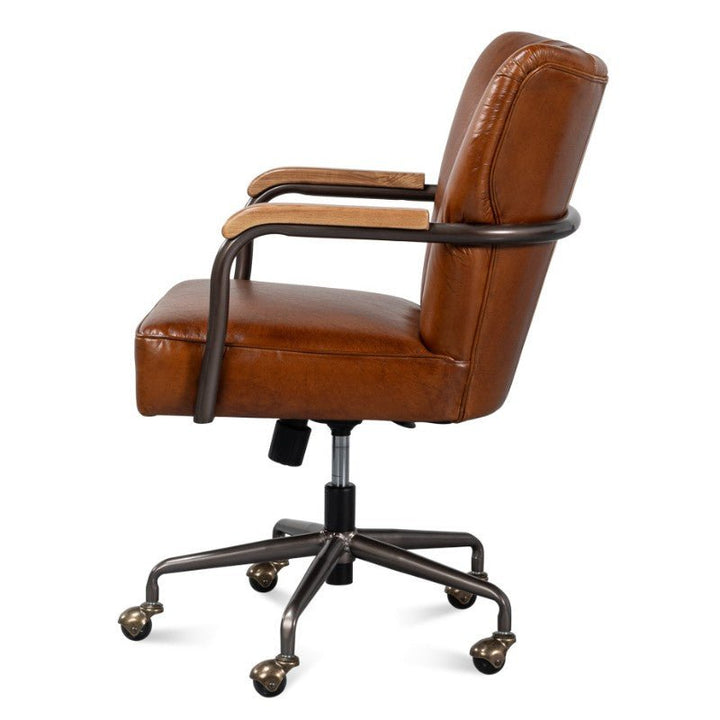 Side view of the Parker Office Chair in Vintage Havana Leather by Sarreid, showcasing top-grain cow leather, padded armrests, a sturdy metal frame, adjustable height feature, and five rolling casters. Its classic design makes it ideal for both professional and home office settings.