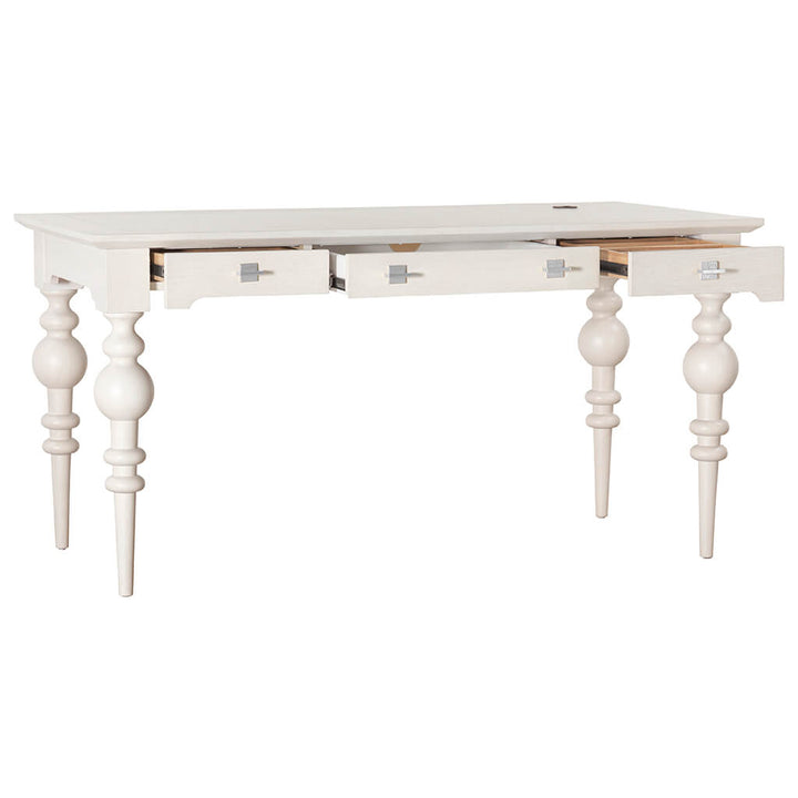 The Portofino Desk from Fairfield Chair, crafted in white wood with intricately turned legs, exudes coastal elegance. Featuring three drawers—one central and one on each side—with partially open side drawers that reveal a glimpse of their contents, this desk's vintage design perfectly complements its refined charm.