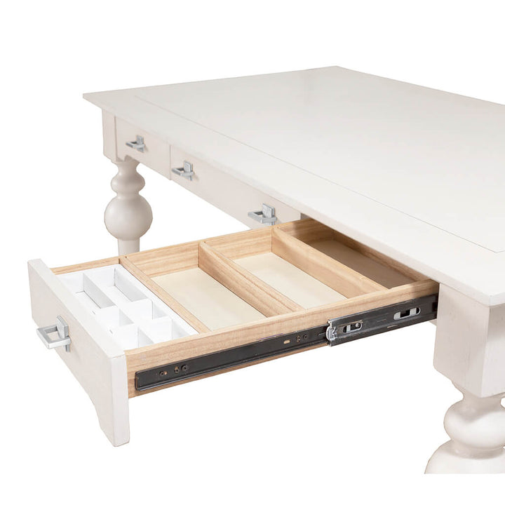 The Portofino Desk by Fairfield Chair, crafted from white wood, features three drawers, including one that opens to reveal multiple storage compartments. This table flaunts sturdy legs with a classic design, and the metallic rectangular drawer pulls enhance both its functionality and style. This desk embodies elegance and practicality.
