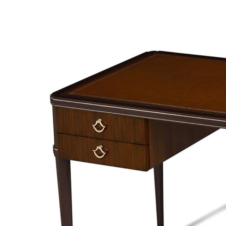 The Rosewood Writing Desk by Aston Court boasts a rich brown finish, showcasing a smooth silver-tooled saddle leather inlay top. It features two drawers on one side, each with metallic handles. The sleek and straight legs accentuate the desk's elegant and classic design.