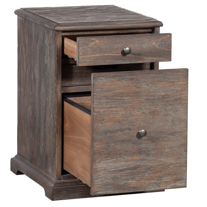 Introducing the Rustique Writing Desk and Mobile File by Fairfield Chair. This piece exudes rustic elegance with its wooden construction and rustic finish, featuring two drawers. The top drawer is partially open, while the larger bottom drawer is fully open, each adorned with round metal knobs. The desk stands on a base with a slightly elevated edge for added style and functionality.