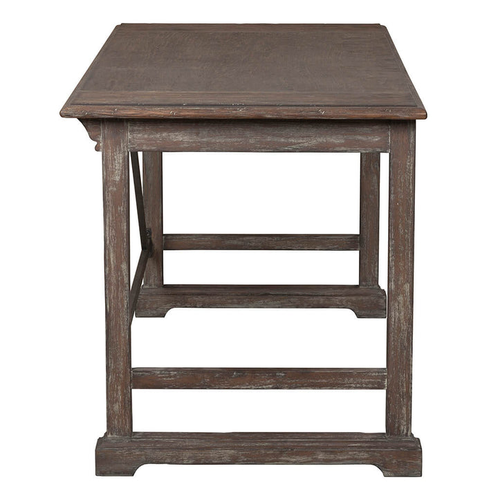 A vintage farmhouse piece from Fairfield Chair, the Rustique Writing Desk and Mobile File features a rectangular top and robust legs interconnected by horizontal supports. The weathered wood with its slightly distressed finish exudes rustic elegance. Photographed from the side, it captures the essence of a timeless aesthetic.