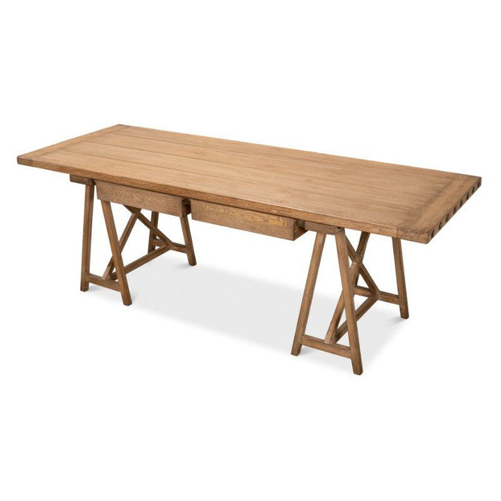 The Sawhorse Desk by Sarreid features a plank-style top and a trestle base, reminiscent of a classic workbench. Crafted from reclaimed pine with two A-frame legs on each side and a central brace for added support, the 87-inch desk is finished in natural polished old pine that highlights its grain, enhancing its rustic charm and sturdy appearance.