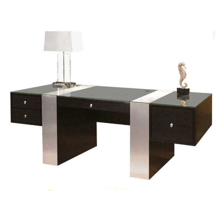 The Sharelle Furnishings Nero Executive Desk - Wenge for the home office showcases a sleek design with a glossy black surface and silver accents. It includes two drawers on each side, a glass lamp with a white square shade on the left, and a decorative seahorse figure on the right. The structure is balanced on sturdy legs with a wenge finish.