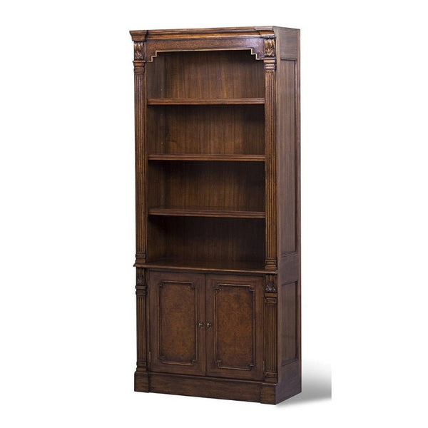 The Aston Court Tall Myrtle Burl Bookcase boasts an ornate design, featuring three adjustable shelves on the upper section and a closed cabinet with two doors on the lower section. Crafted from rich, dark brown luxurious myrtle burl, this piece is adorned with decorative carved details on the corners and edges.