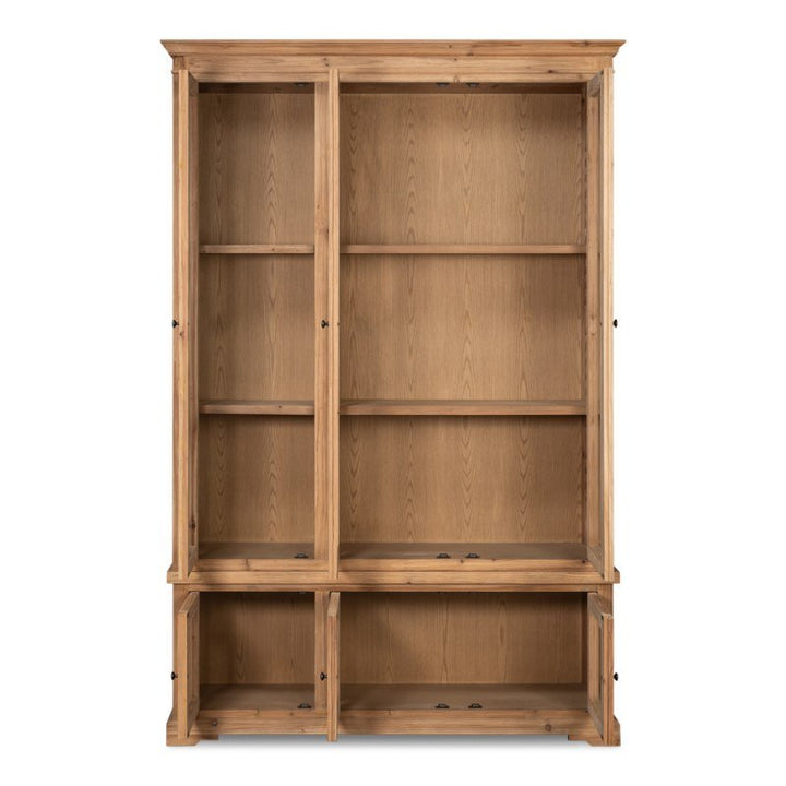 The Tanner Bookcase, Natural by Sarreid is a tall wooden bookcase crafted from reclaimed pine, featuring adjustable shelves in the upper section and open compartments in the lower section. With its natural brushed finish, this classic piece showcases a rustic design with visible wood grain and simple, functional styling.