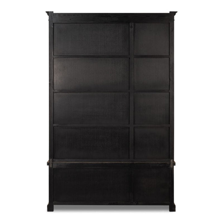 A tall, black wooden structure with a rectangular, multi-panel design, it appears to be a large standing storage unit or cabinet. The surface has a matte finish with visible wood grain texture. Reminiscent of the Tanner Bookcase, Natural from Sarreid, it features natural brushed finishes and a series of vertical and horizontal panels.