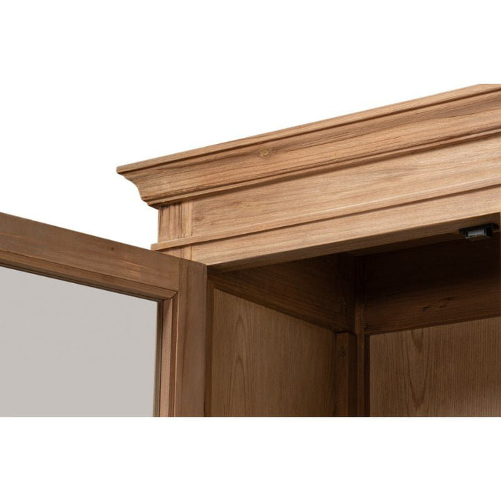 Close-up view of an open wooden Tanner Bookcase by Sarreid, showcasing the corner detail of its crown molding. The image focuses on the upper section of the bookcase, highlighting its reclaimed pine construction with a natural brushed finish and smooth texture.