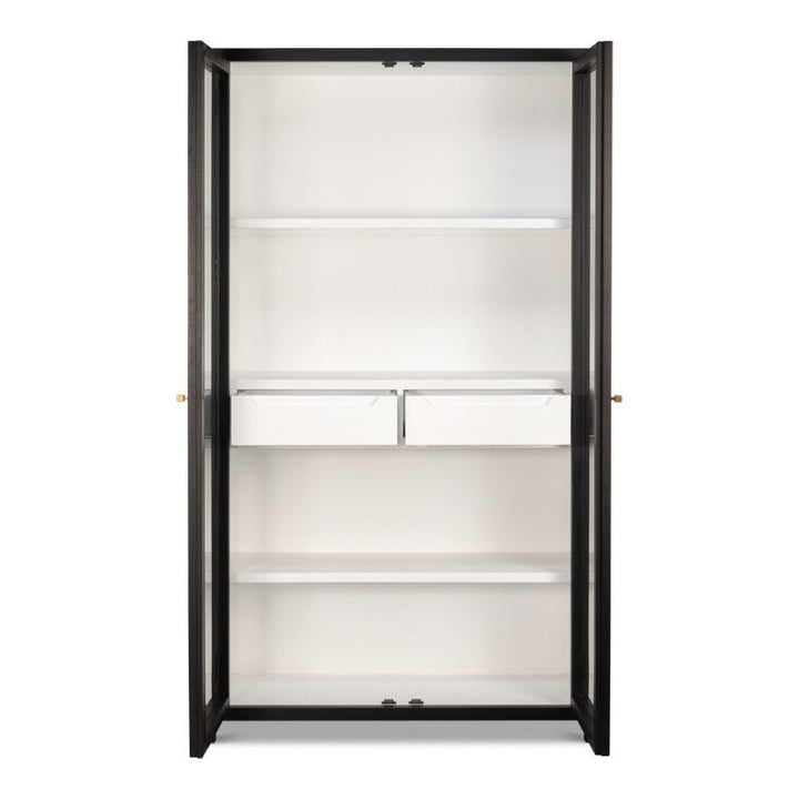 Introducing the Walker Bookcase by Sarreid: A tall, black metal-framed bookcase with transparent glass doors and a brushed black exterior. Inside, it showcases three spacious white shelves and two small white storage boxes in the middle section, perfectly embodying rustic elegance. The stylish bookcase stands empty against a plain white background.